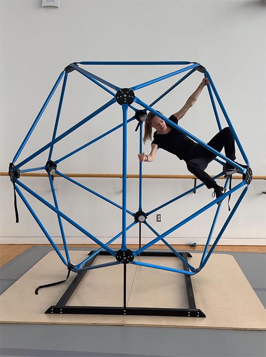 woman climbing inside an icosahedron
